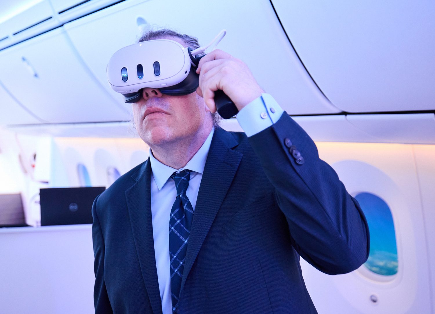 Passenger wearing a mixed-reality headset in an aircraft cabin